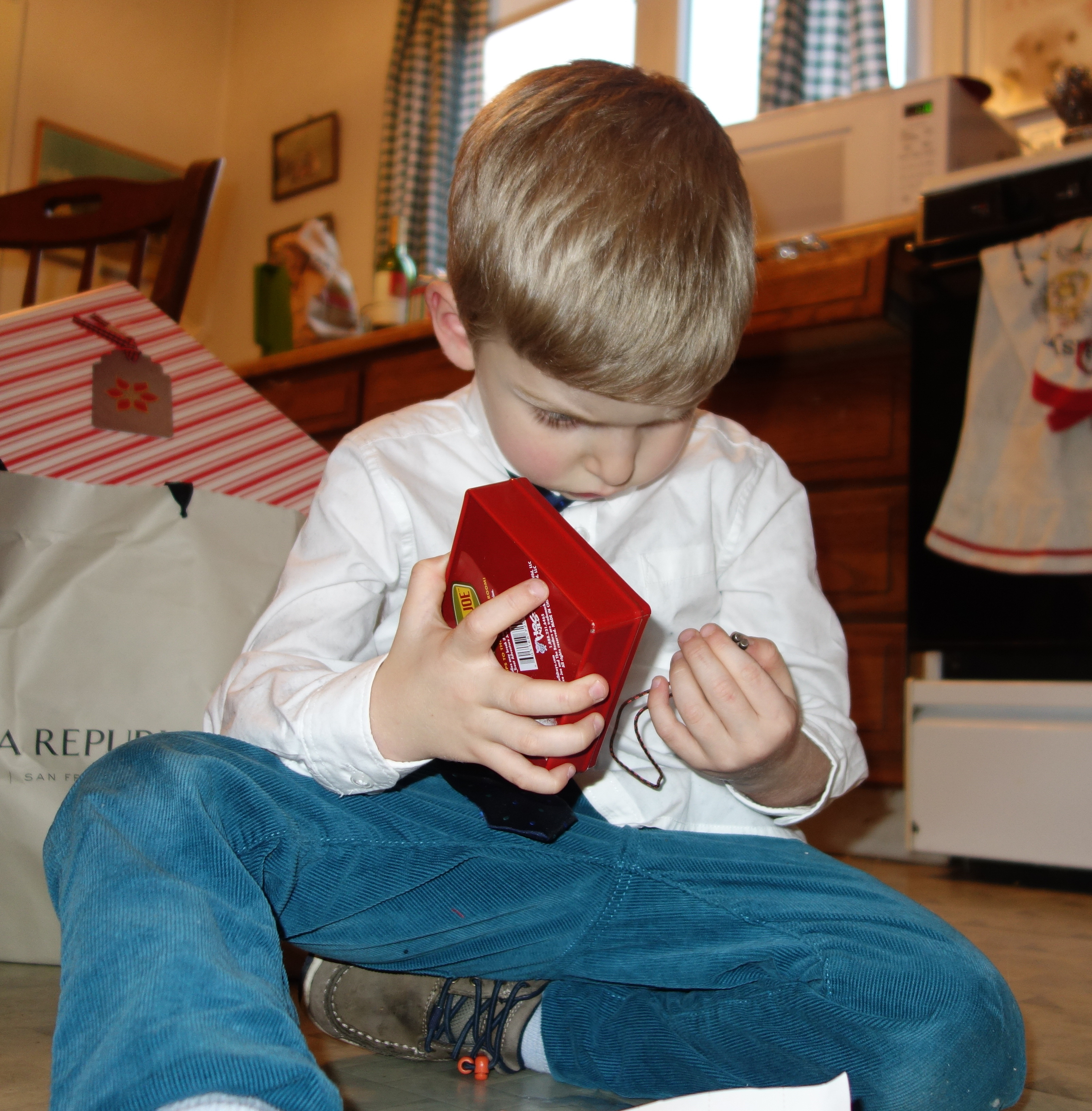 Alexander attends to a present on Christmas Day.  He can become engrossed.